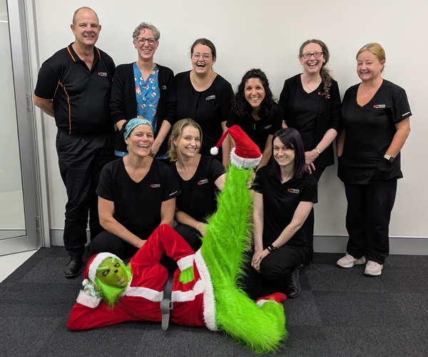 The Genesis Research Services team pictured with the Grinch for Christmas