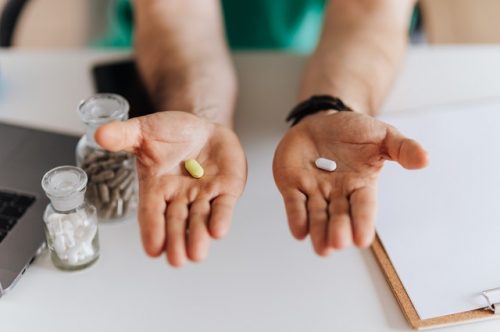 Clinical trial study doctor holding study treatment and placebo pill